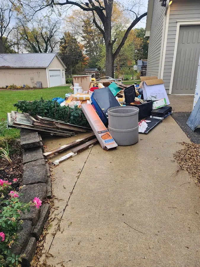 Dumpster being loaded with debris for Estate Cleanout Dumpster Rental in Millburn